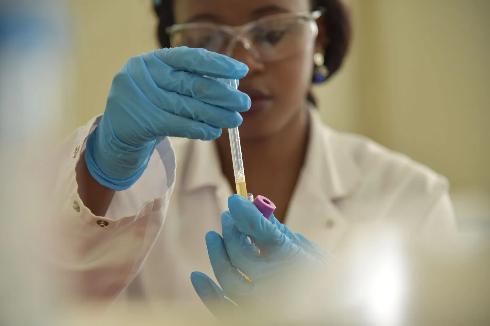 Representative laboratory professional handling a specimen tube